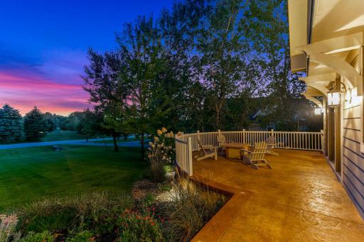 Curved stamped concrete patio at the front of the home, outside dining room making it perfect for a fire table and/or outdoor dining.