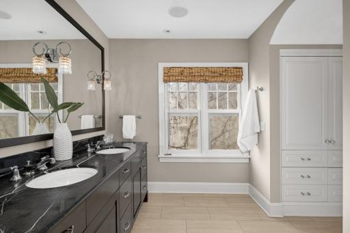 A very nice timeless bath with double marble vanity and heated floors