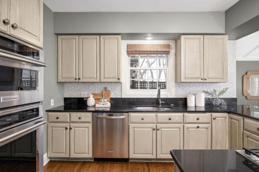 There are granite countertops and a herringbone back splash