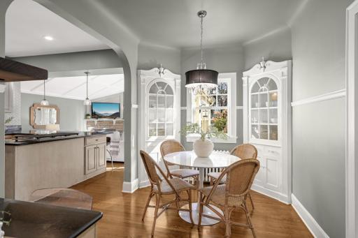 The kitchen features a charming family dining area with original corner cabinets