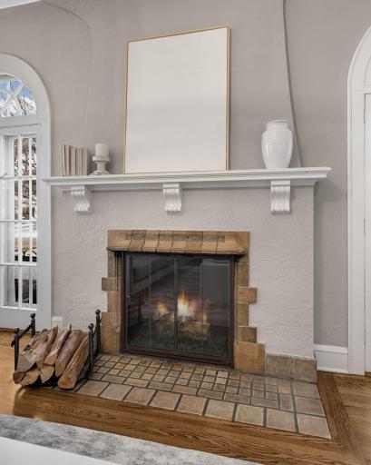 A wood burning fireplace with original "Batchelder tiles" in the mantel