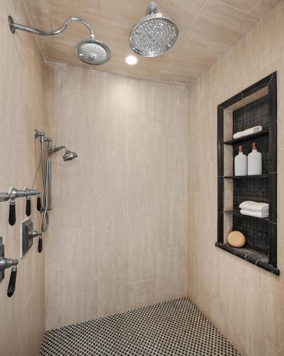A roomy Primary shower with 3 shower heads.