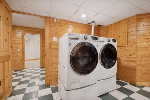 Spacious laundry room, equipped with a utility sink, countertop and shelving for organization