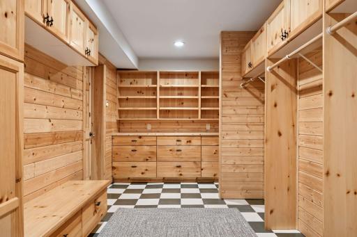 Gorgeous knotty pine mud room off the side entrance with an abundance of storage for your coats and shoes