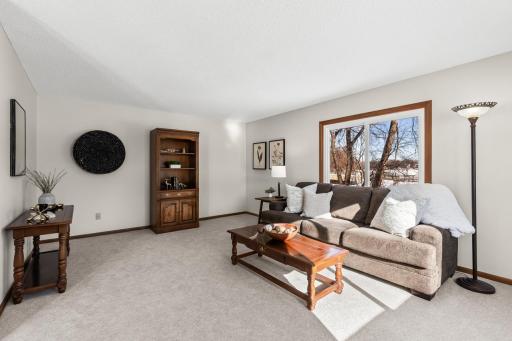 Sun-filled interior with expansive windows showcasing breathtaking lake views