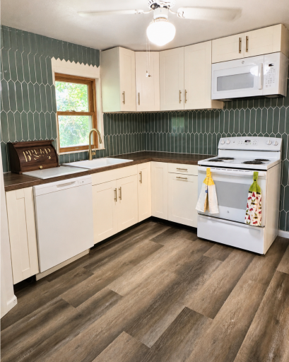 Thoughtfully updated kitchen features new cabinetry, countertops, backsplash, added storage and updated appliances. Tile will be finished before home is ready for showings.