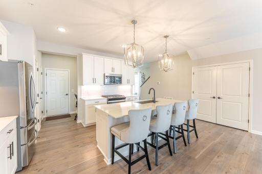 So much natural light beams through to the kitchen. Extra room for family and guests with the island Seating