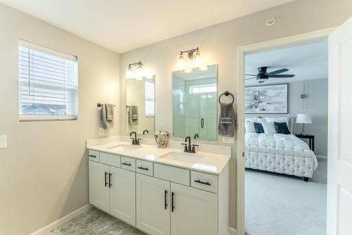 Primary bath with dual sinks and raised vanity.