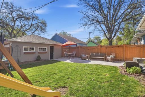 Outside, step into a fenced backyard with a swing set, a cement patio, a two-car garage, and plenty of space to enjoy the outdoors.