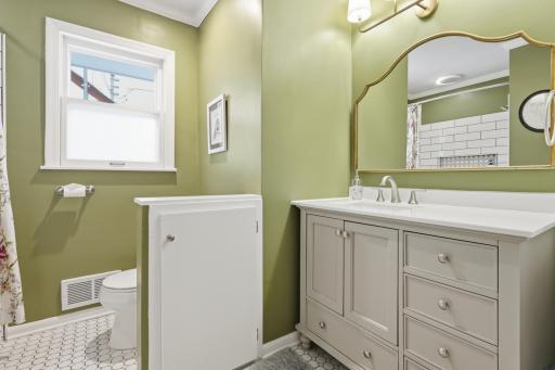The updated main-level bathroom features modern fixtures and a clean, refined look that complements the homeâs overall feel.