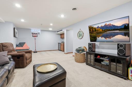 This level features a spacious living and entertaining area complete with a bar, creating the perfect setting to relax or gather.