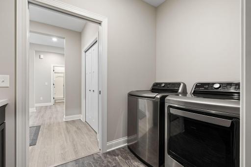 Main floor laundry room includes custom under-counter laundry baskets