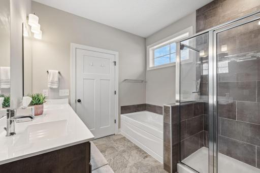 A window above the tub offers great natural light in the space