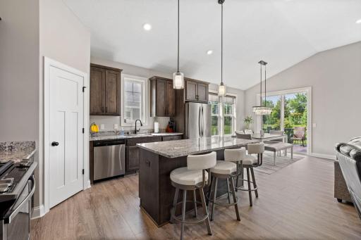 Enjoy a beautifully designed kitchen with granite countertops, stainless steel appliances, a large island, and walk-in pantry