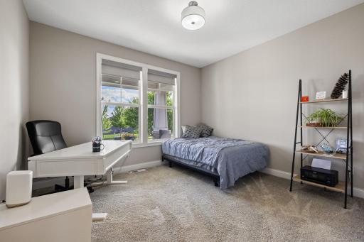 A versatile main-level bedroom works perfectly as a home office, guest room, or flex space