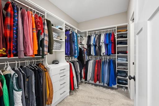 Well-appointed custom closet with built-in shelving designed to maximize space and organization
