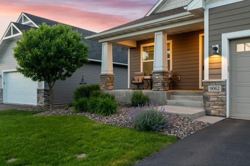 Cozy front porch accented by perennial landscaping