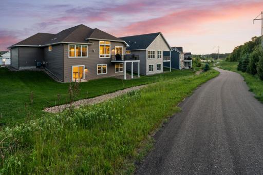 Enjoy easy access to a scenic walking and biking path right out your back door, framed by a beautiful tree-lined view