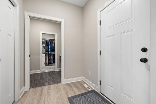 The mudroom provides a custom bench with seating for putting on shoes and a storage closet to keep things organized