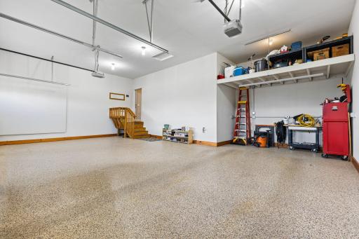 Custom mezzanine over the extended third-stall garage adds flexible and accessible storage options