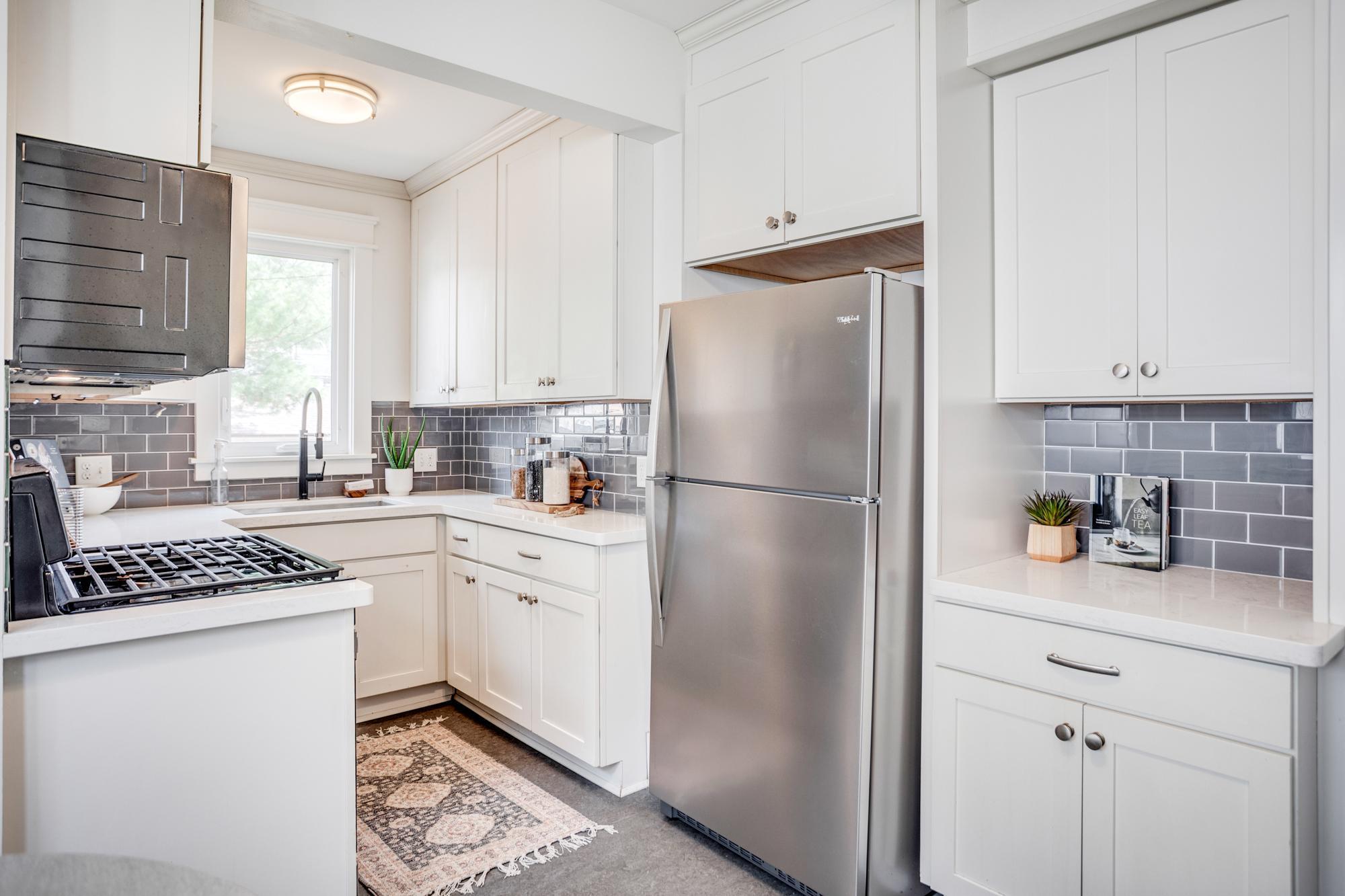 Recently updated kitchen with subway tile backsplash, quartz counters and stainless-steel appliances