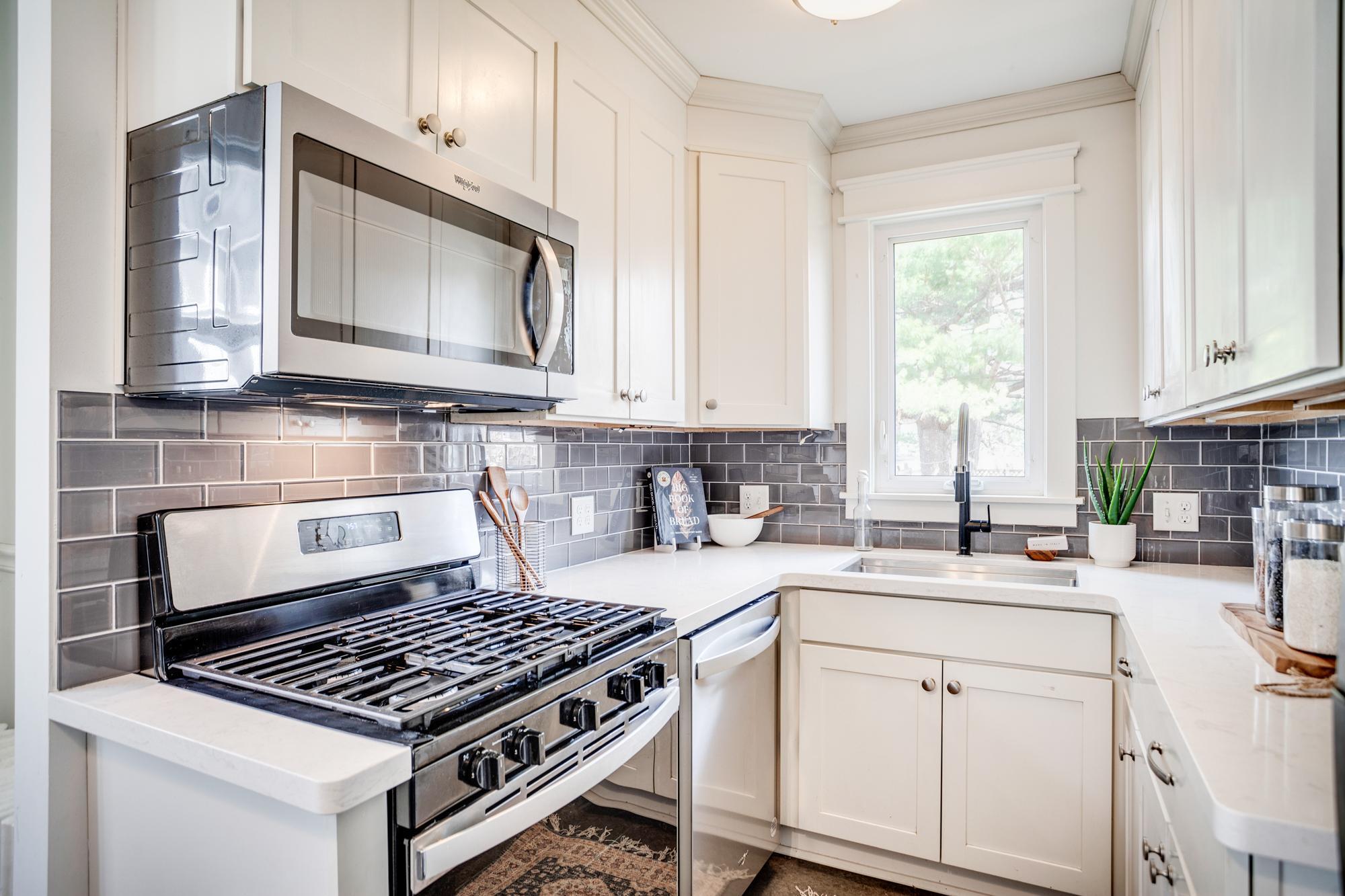 Recently updated kitchen with subway tile backsplash, quartz counters and stainless-steel appliances