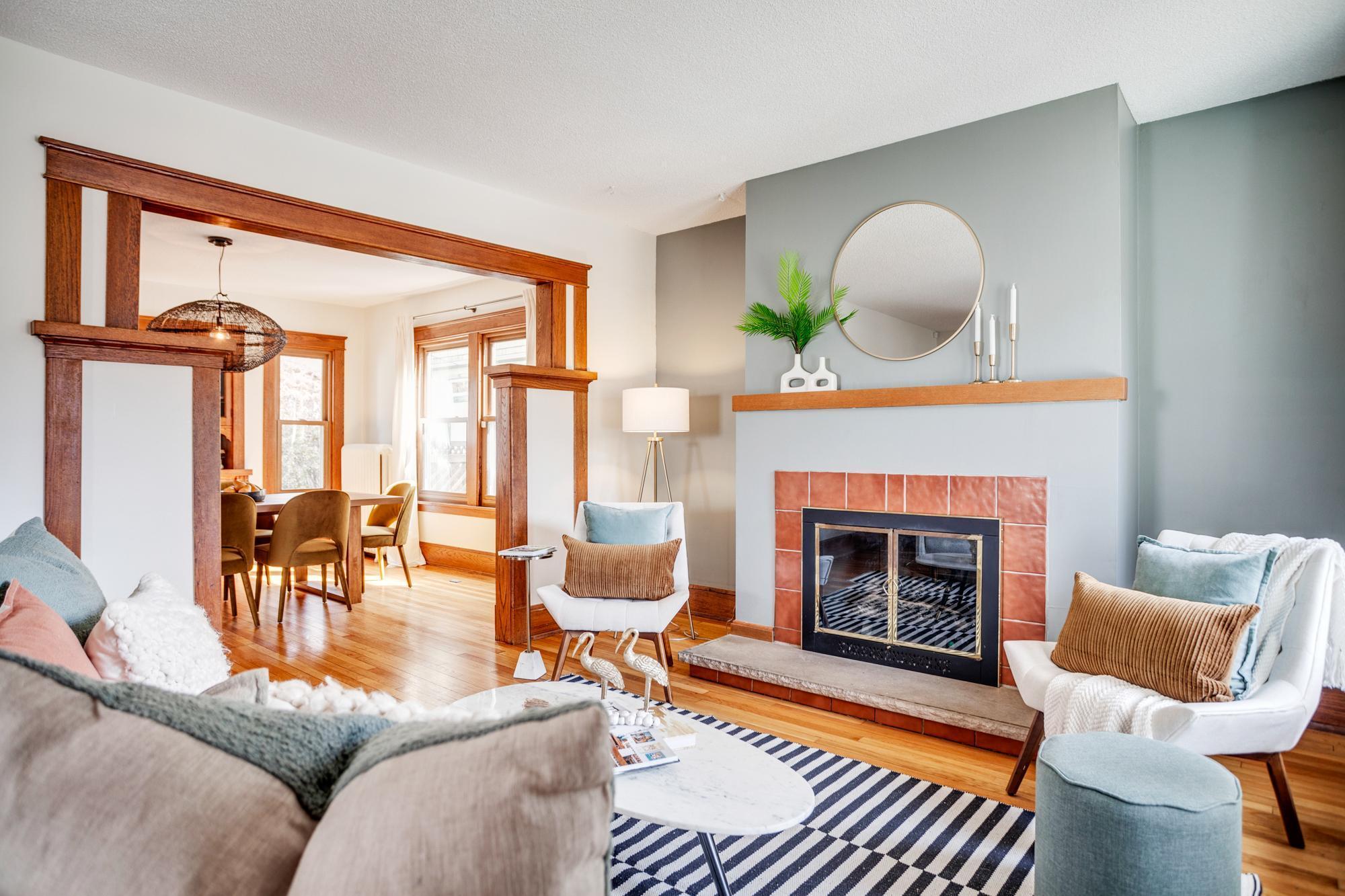 The main level features a large living room with a fireplace that flows into the formal dining room