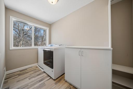 Not just a laundry closet. This spacious upper level laundry room has room to fold and hang.