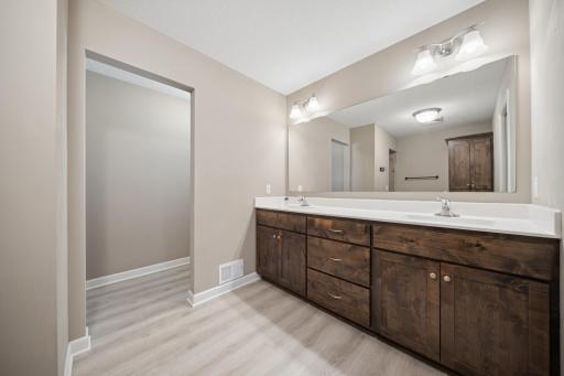 Primary bath features double sinks, built-in linen, and wait until you see the huge shower with TWO shower heads!