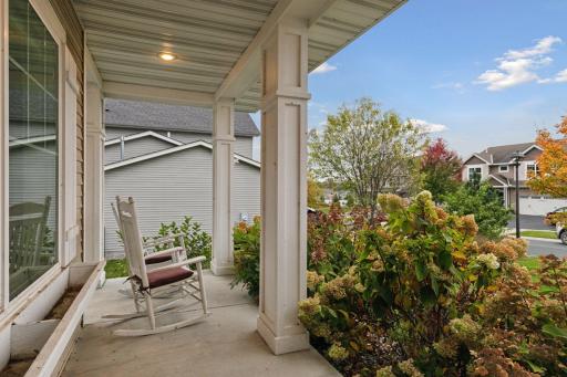 Gorgeous and full hydrangeas line the covered front porch. Flower boxes and shutters add curb add to the curb appeal.
