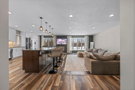 Open and bright main level featuring LVP flooring & a high-end kitchen