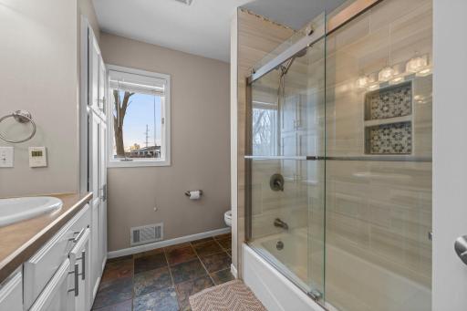 Bathroom includes a stunning tile shower & floors, and a double vanity
