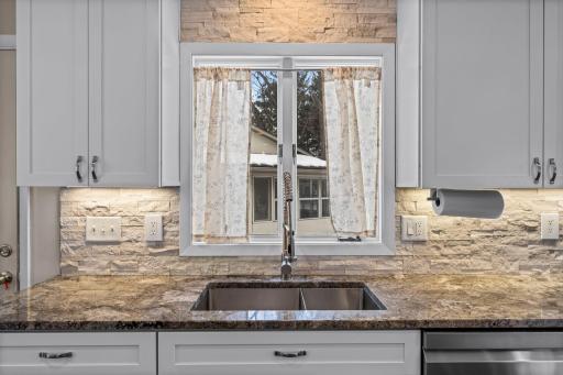 Window above the kitchen sink and under-cabinet lighting add a high-end touch