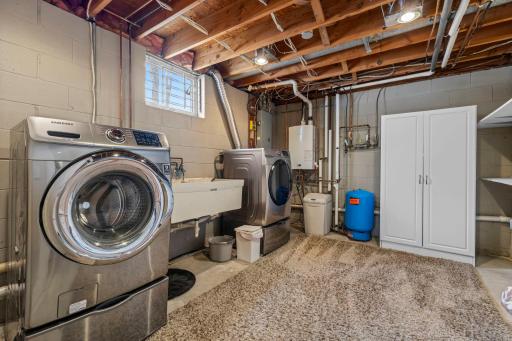 Lower level laundry room with deep sink and great storage space