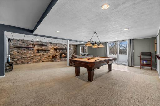 Large walkout lower level family & rec room has plenty of space to lounge & entertain