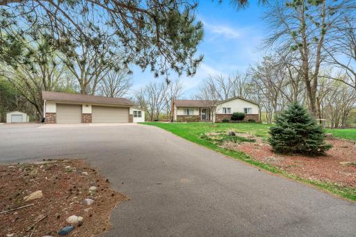 Set back off the road, a long wraparound driveway leads up to the home