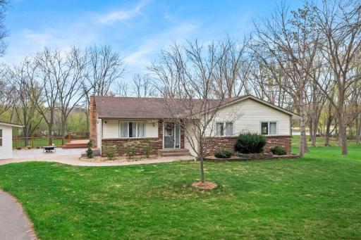 Quaint curb appeal with mature trees offering beautiful summer and fall color