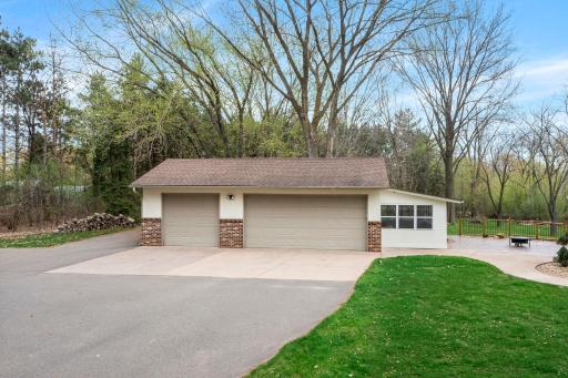 Easy access to a 3-car detached garage with sunroom and additional driveway parking space