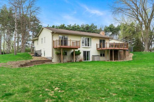 Back exterior includes a walkout lower level with easy access to the backyard