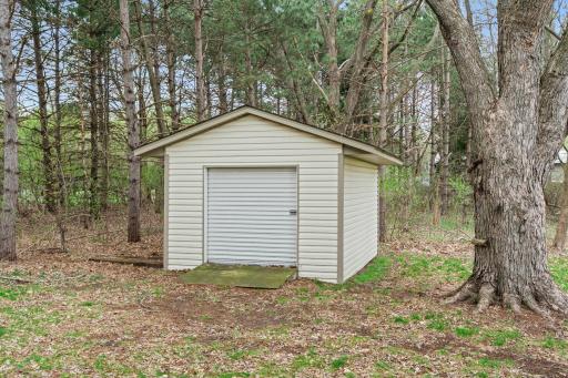 Storage shed in the backyard offers easy storage for lawn and garden items