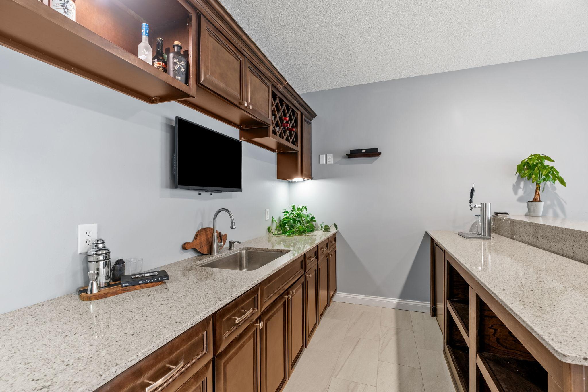 Walk-out LL features spacious Wet Bar with quartz counters, abundant cabinetry, refrigerator & kegerato