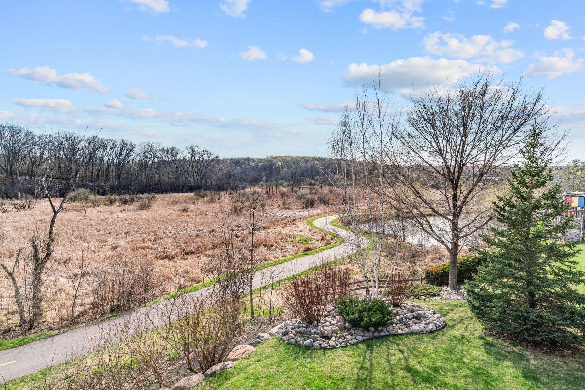 Overlooks private backyard with stunning wetland views & direct access to the Greenway