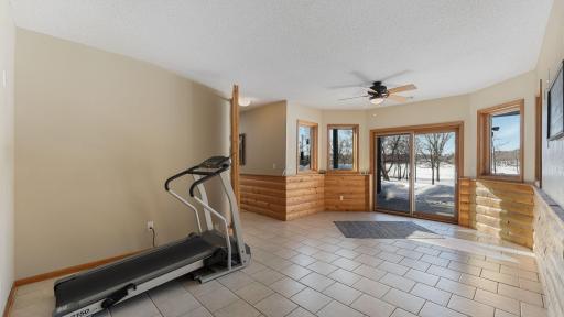 Flex room being used as a workout area, gains access to lower level patio.