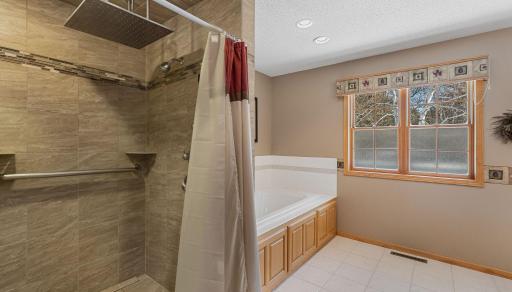 Private primary bathroom with a separate tub and shower.