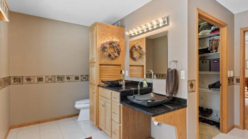 Storage for your bathroom necessities and design flare with vessel sinks. Note the accessible sink access.