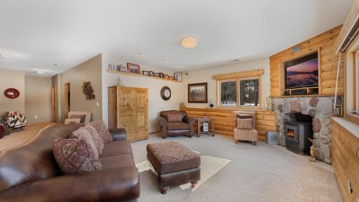 Lower level living boast look out windows and a wood fireplace.