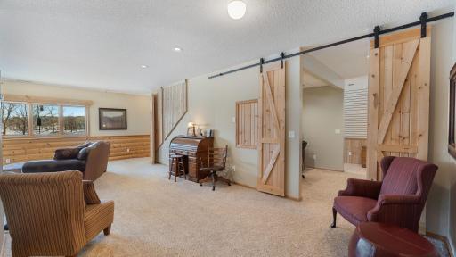 Appreciate the modern barn doors that lead to flex space for hobby, office, or bunk space.