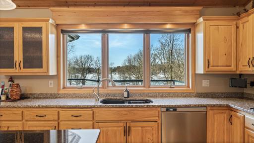 Kitchen window overlooks the water. Notice the large amount of counter space and the undermount lights.