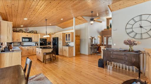 Open-concept layout with soaring ceilings and abundant natural light, the dining opens to kitchen and foyer.