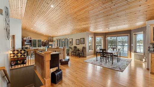 Upper level dining is a great place to gather and entertain as it overlooks the water and gains access to walk around deck.